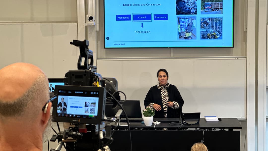 En man filmar en person som står på en scen
