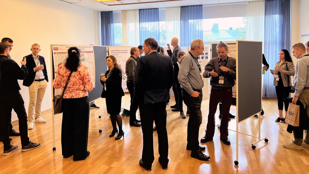 Men and women viewing research posters.