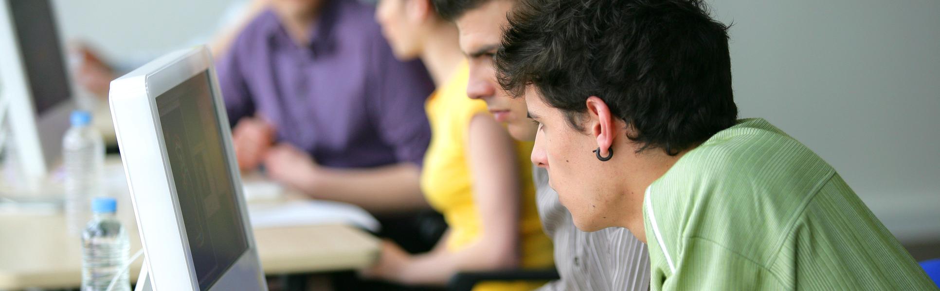 2730616-young-men-using-a-computer-in-the-classroom.jpg