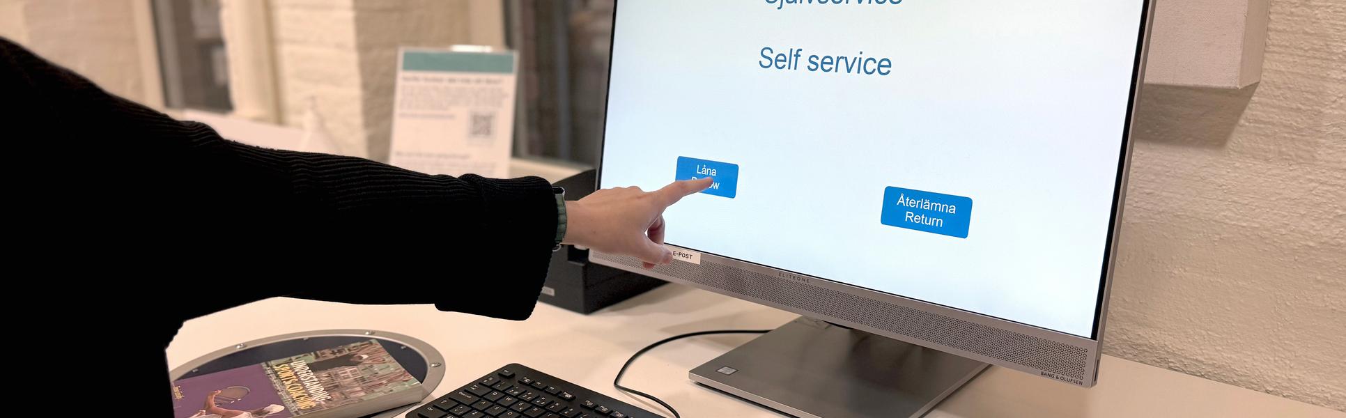 hand pointing at a screen