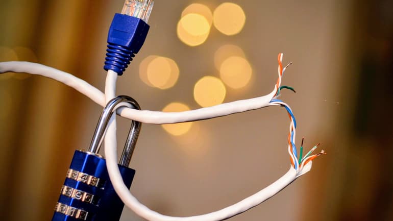 A broken ethernet cable with a blue lock hanging from it