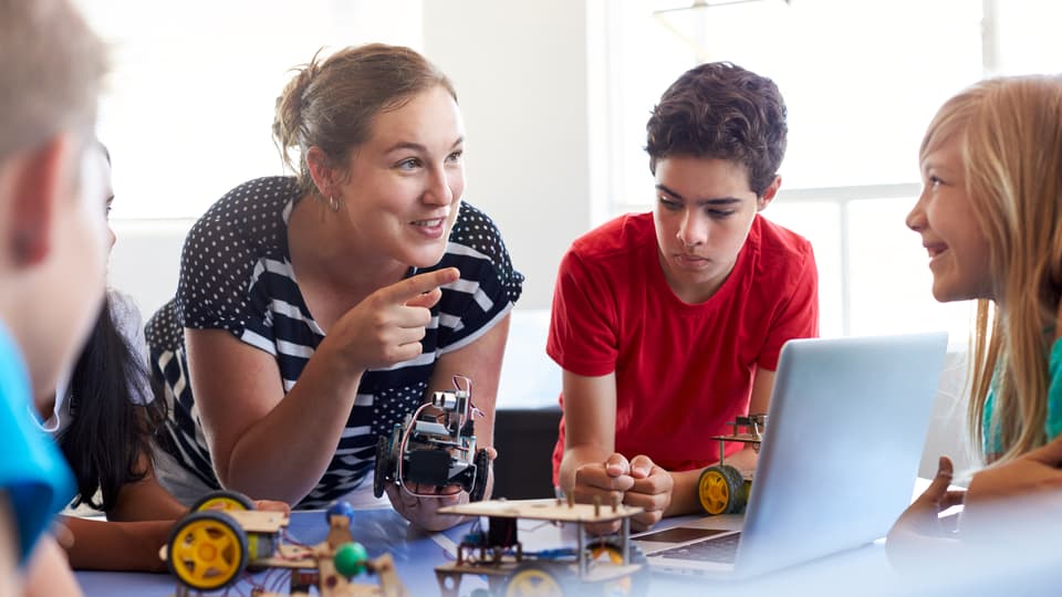 32775085-students-in-after-school-computer-coding-class-building.jpg