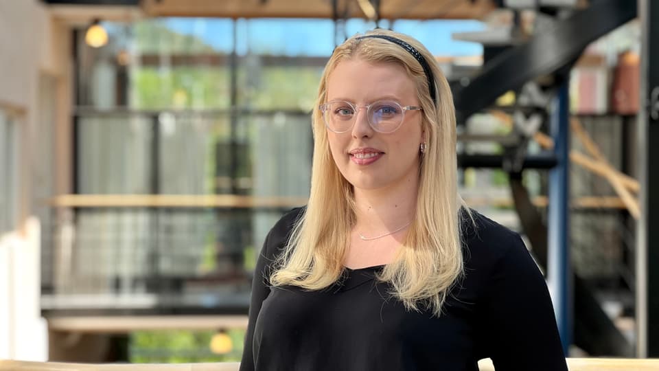 En blond kvinna med glasögon och svart tröja