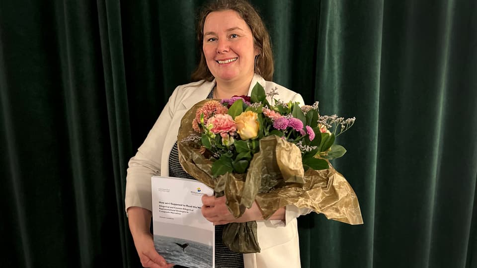 A woman is holding a bouquet of flowers.