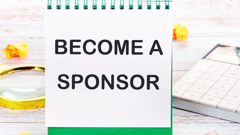 The text Become a sponsor is written in capital letters in a notepad.